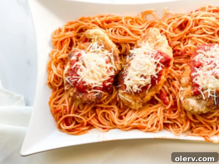 Effortless Chicken Parmesan 3 Ingredients for chicken parmesan laid out on a table