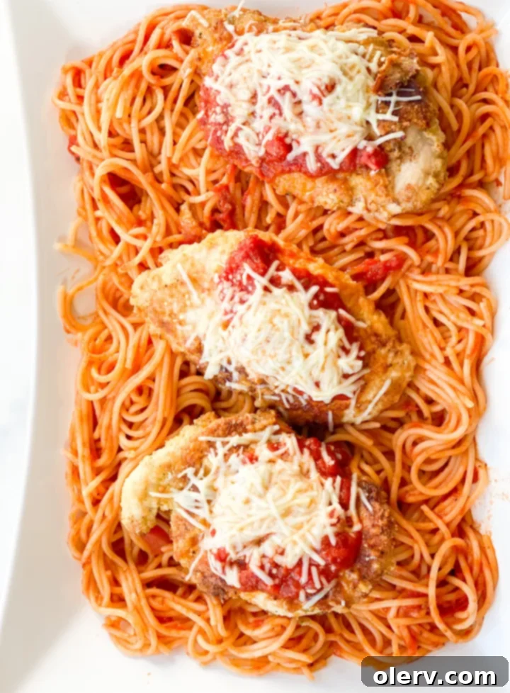 Effortless Chicken Parmesan 5 Raw chicken cutlets coated in breading, ready for cooking