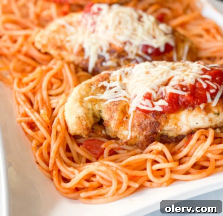 Effortless Chicken Parmesan 6 Close up of cooked chicken parmesan with melted cheese