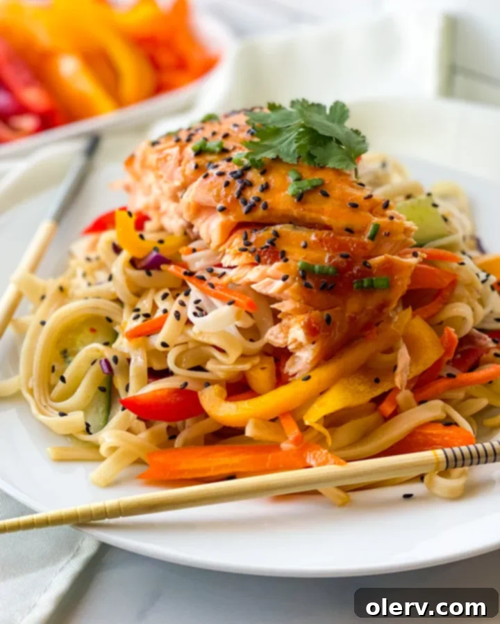 Glazed Teriyaki Salmon Bowl 2 Delicious Teriyaki Salmon Bowl with fresh Bluehouse Salmon, rice noodles, and colorful vegetables, garnished with sesame seeds and green onions.