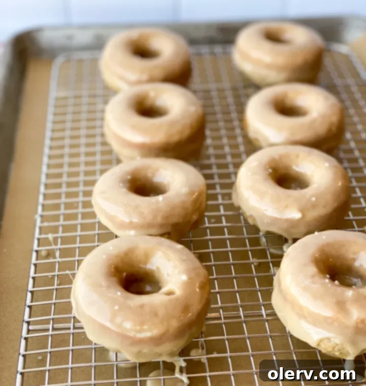 Effortless Maple Baked Donuts 5 Ingredients for baked maple donuts laid out on a kitchen counter, including flour, sugar, butter, and milk.