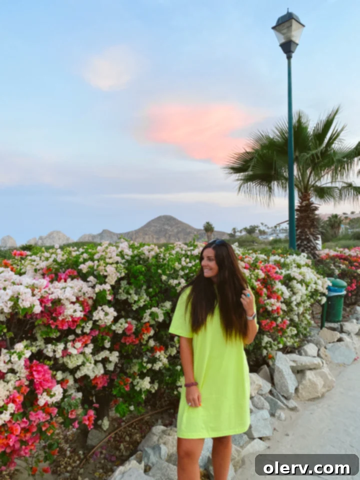 Unlock Cabo San Lucas Your Essential Guide to an Epic Escape 14 Smiling woman enjoying a sunny day at a luxurious resort pool in Cabo San Lucas, epitomizing vacation bliss.