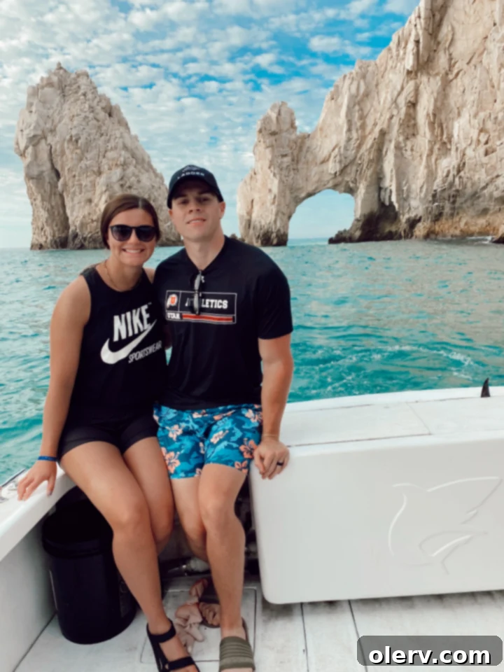 Unlock Cabo San Lucas Your Essential Guide to an Epic Escape 9 Tourists enjoying the calm waters of Lovers Beach with the iconic El Arco rock formation in the background.