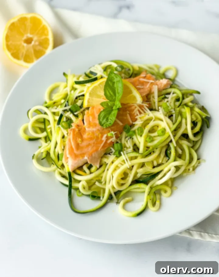 Zesty Salmon with Zucchini Ribbons 6 Finished Lemon Salmon with Zucchini Noodles on a plate, garnished with fresh herbs