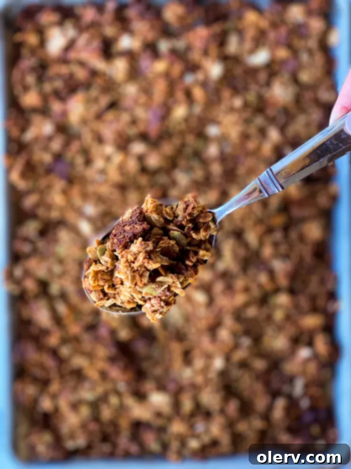 Maple Almond Delight 8 Maple almond granola with a spoon, ready to be served