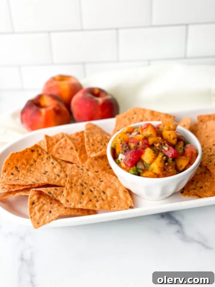 Sun-Kissed Peach Salsa 4 Various fresh ingredients laid out on a cutting board, including ripe peaches, tomatoes, red onion, jalapeño, cilantro, and limes, ready for dicing and mincing.