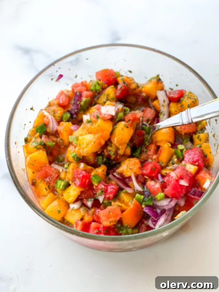 Sun-Kissed Peach Salsa 6 A bowl of fresh peach salsa on a rustic wooden table, with a serving spoon resting in the bowl, ready for enjoyment.