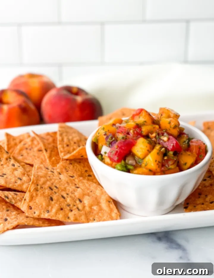 Sun-Kissed Peach Salsa 8 A beautifully presented bowl of Fresh Peach Salsa, highlighting its vibrant colors and chunky texture, ready to be served.