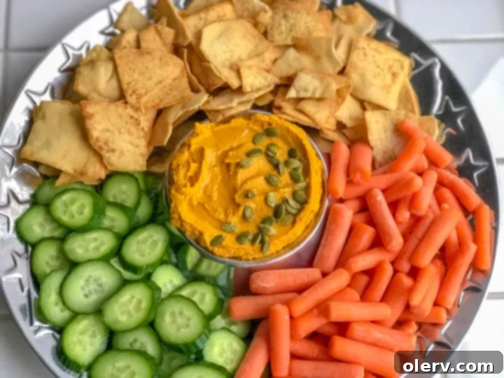 Savory Pumpkin Hummus served with pita chips and vegetables