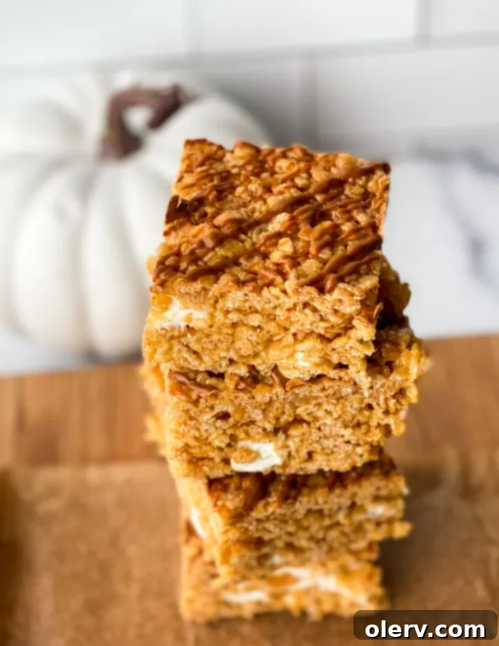 Autumn Pumpkin Crispy Delights 3 Close-up of freshly made pumpkin rice krispie treats on a cutting board