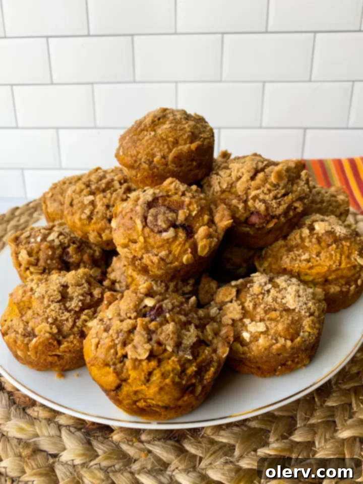 Cozy Autumn Muffins 4 Ingredients for pumpkin zucchini muffins laid out on a kitchen counter, including pumpkin puree, spices, and shredded zucchini.