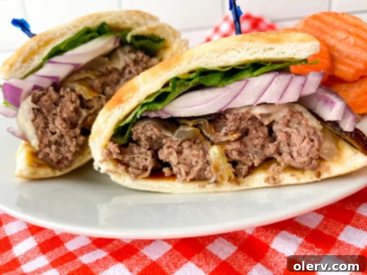 Perfect Air Fryer Burgers 4 A person placing hamburger patties into an air fryer basket for cooking.