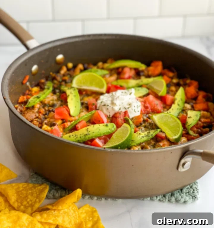 One-Pan Skillet Enchiladas 7 A serving of Skillet Enchiladas with sour cream, avocado, and lime