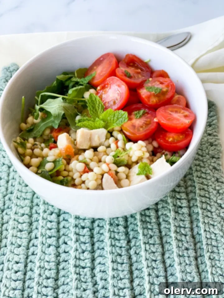 Vibrant Lemon Arugula Couscous Medley 3 Close-up of the lemon arugula couscous salad showing the pearl couscous and fresh vegetables.