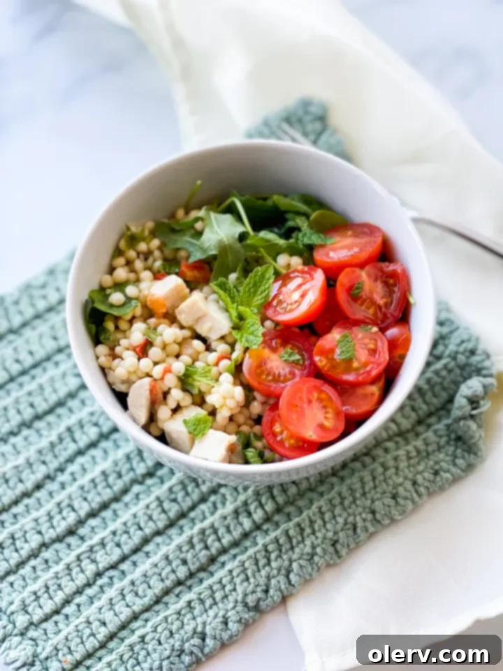Vibrant Lemon Arugula Couscous Medley 5 A close-up shot of the finished lemon arugula couscous salad in a serving bowl.
