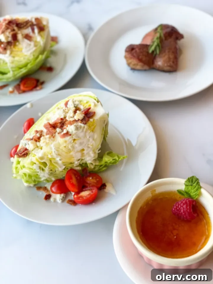 Crisp Wedge Salad 5 Overhead view of a prepared Iceberg Wedge Salad with blue cheese, bacon, and tomatoes on a white plate.