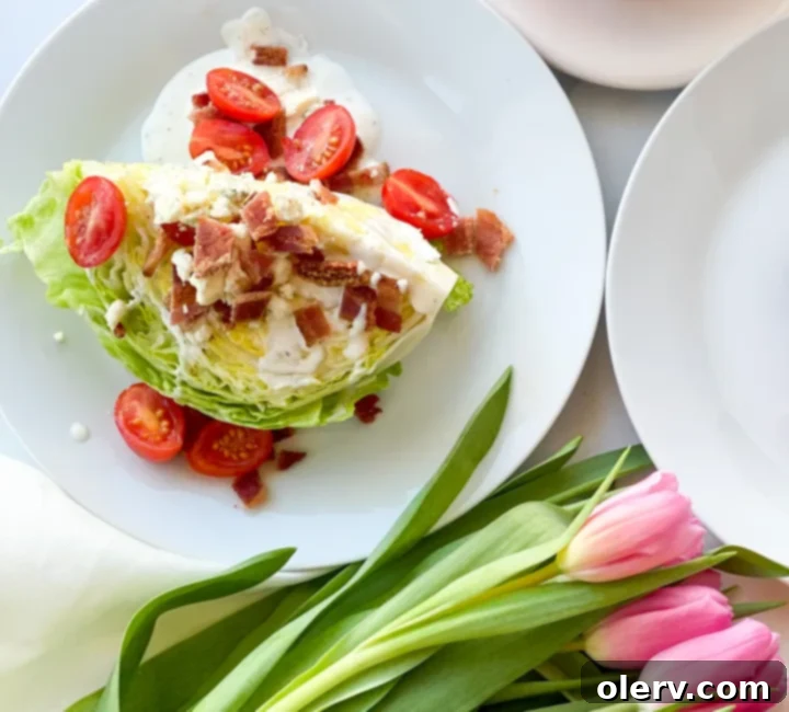 Crisp Wedge Salad 6 Hand drizzling blue cheese dressing over a beautifully assembled Iceberg Wedge Salad.