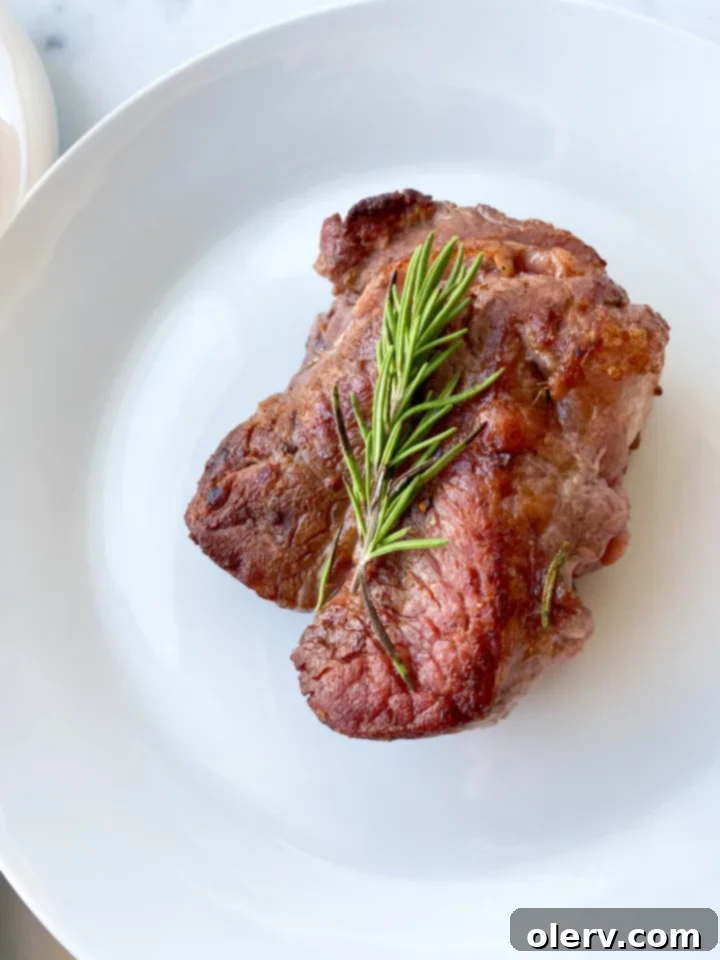 Our Own Romantic Restaurant 5 A perfectly seared and butter-basted steak resting on a cutting board, ready to be sliced for a gourmet home dinner.