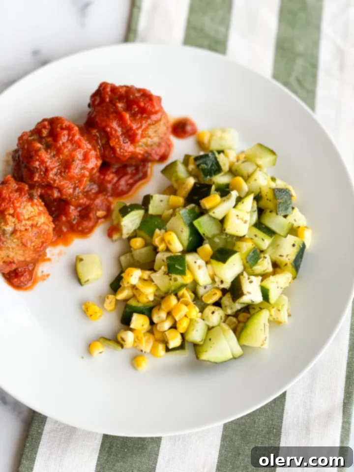 Savory Zucchini Side 6 Served bowl of zucchini and corn side dish with a fork, ready to eat