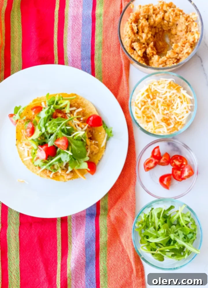 Crispy Chickpea Tostadas 6 A beautifully plated vegetarian chickpea tostada with a fork, ready to be eaten.