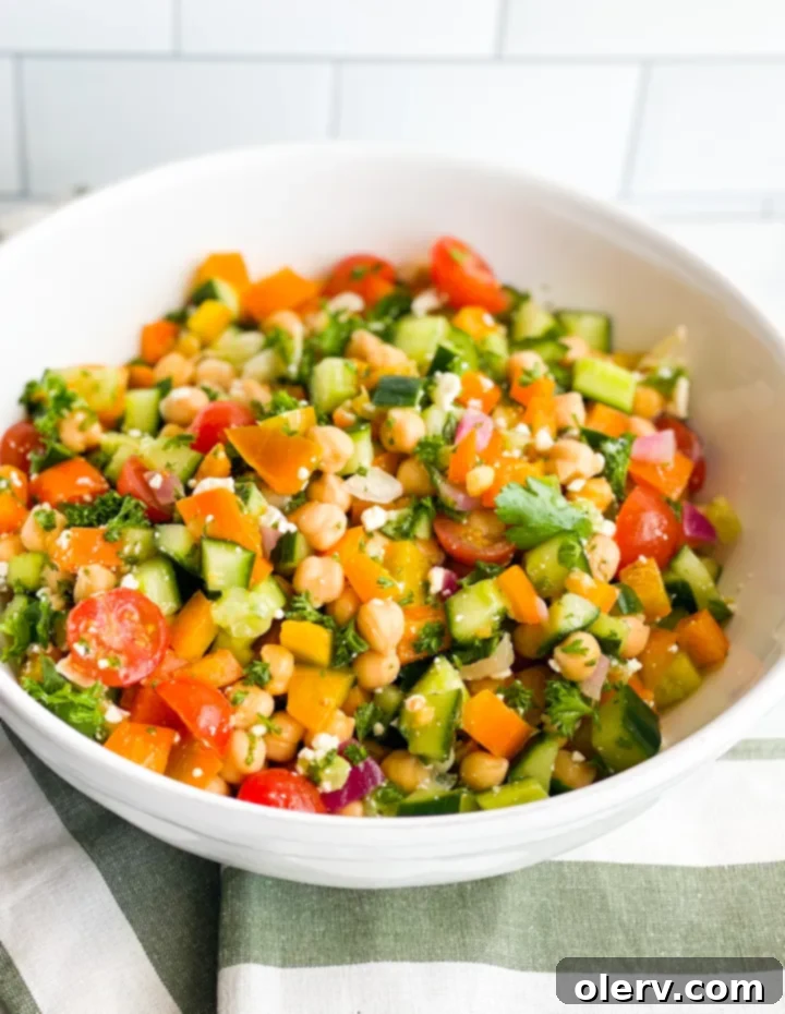 Vibrant Greek Chickpea Salad 2 Close-up of a vibrant Greek Chickpea Salad in a bowl, ready to serve.