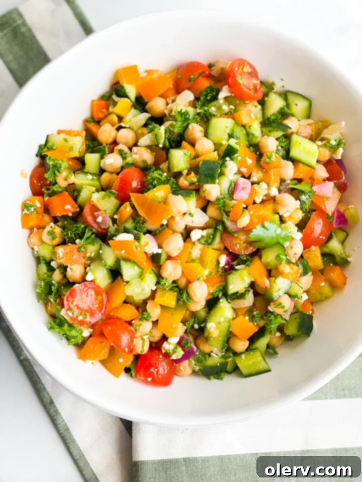 Vibrant Greek Chickpea Salad 4 A bowl of freshly made Greek Chickpea Salad with feta cheese sprinkled on top.