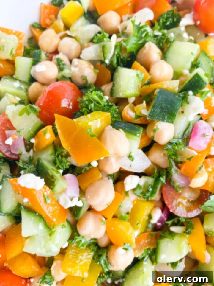 Vibrant Greek Chickpea Salad 6 A large bowl of colorful Greek Chickpea Salad, freshly mixed and ready to be enjoyed.