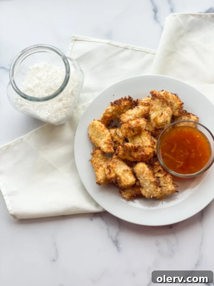 Golden Coconut-Crusted Chicken 2 Plate of golden-brown crispy coconut chicken nuggets, ready to be served.