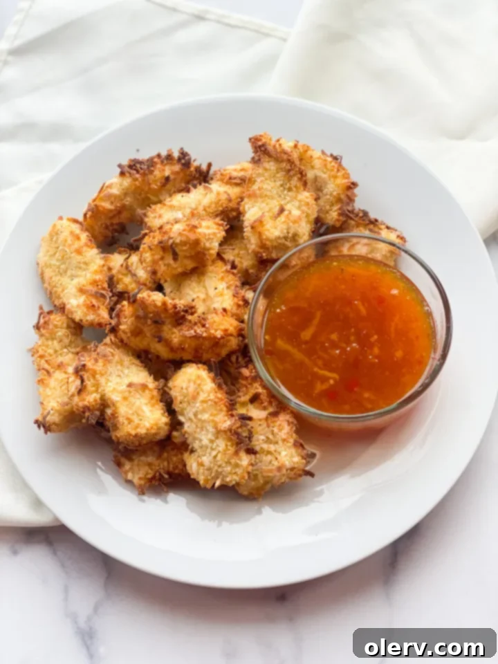 Golden Coconut-Crusted Chicken 3 Close-up of perfectly air-fried crispy coconut chicken nuggets, highlighting their golden texture.