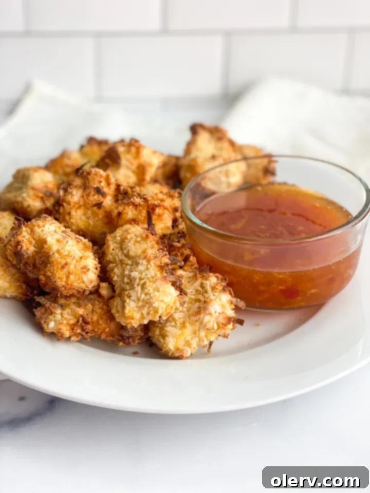 Golden Coconut-Crusted Chicken 6 A serving of crispy coconut chicken nuggets accompanied by the sweet chili dipping sauce.