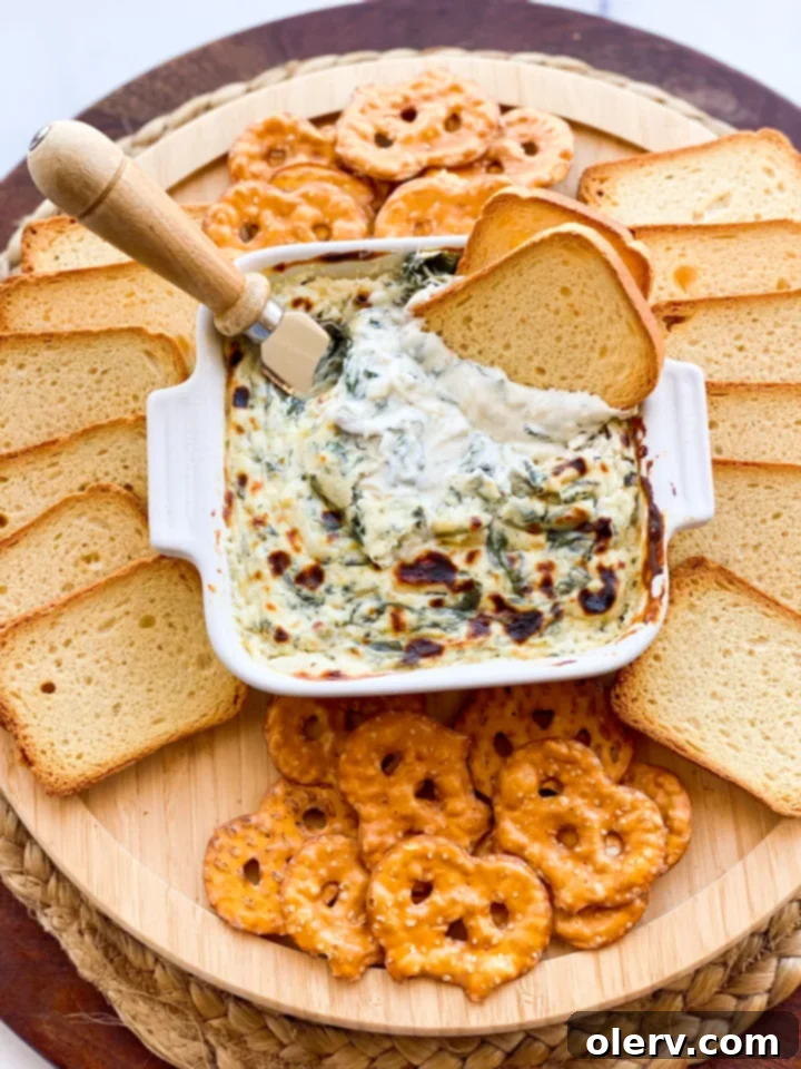 Effortless Oven Baked Spinach Artichoke Dip 2 Deliciously creamy baked spinach and artichoke dip in a baking dish
