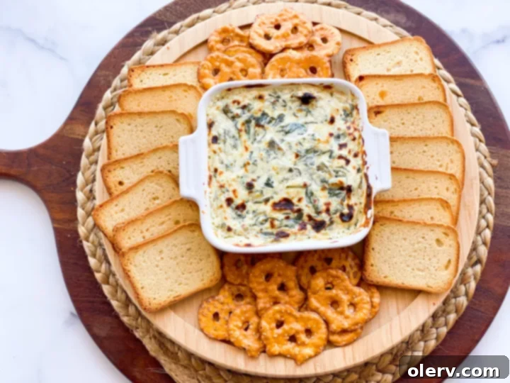 Effortless Oven Baked Spinach Artichoke Dip 3 Ingredients for spinach and artichoke dip laid out on a kitchen counter