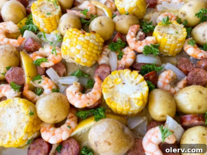 Sheet Pan Shrimp Feast 4 A close-up shot showcasing the golden-brown crust of roasted potatoes and the juicy texture of shrimp and sausage, fresh out of the oven in a sheet pan shrimp boil.