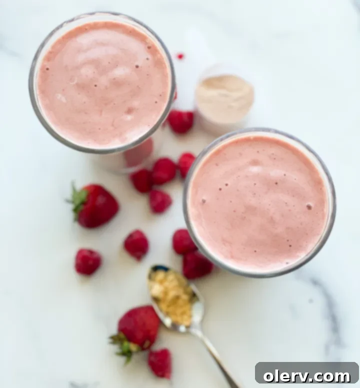 Berry Chocolate Protein Boost 3 Assorted protein shake ingredients including fresh berries, banana, peanut butter, and protein powder laid out on a kitchen counter