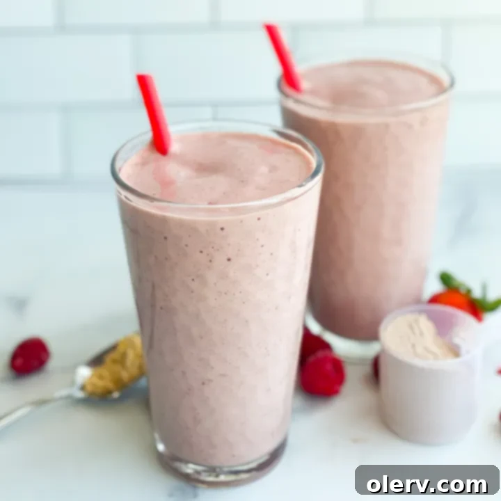 Berry Chocolate Protein Boost 5 A close-up of a perfectly blended Berry Chocolate Protein Shake in a clear glass, showing its smooth texture