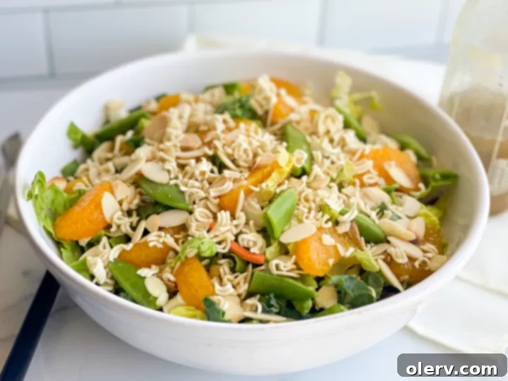 Mandarin Sesame Chicken Salad 3 Freshly chopped salad ingredients including cabbage, chicken, and mandarin oranges.