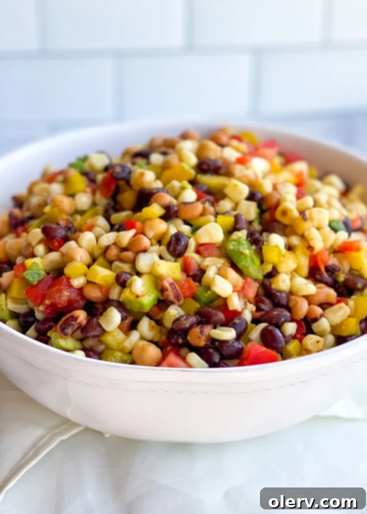 Ranch Rhapsody Dip 3 A large serving bowl filled with colorful Cowboy Caviar, ready for a party. The dip is garnished with fresh cilantro.