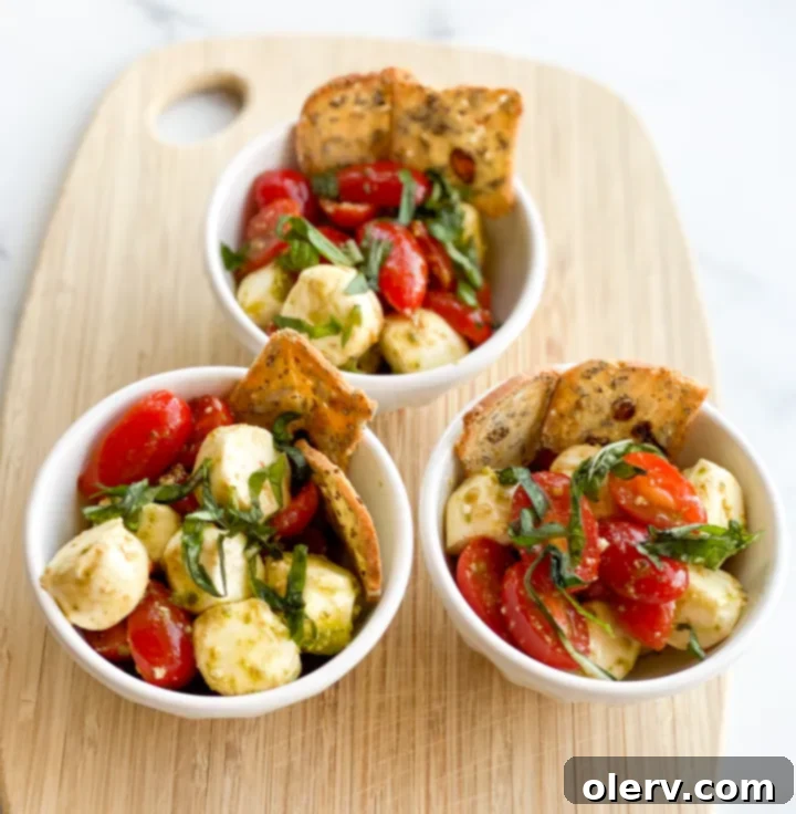 Garden Caprese Delights 4 A closer view of Caprese Appetizer Cups with a crostini stick, highlighting the fresh ingredients.