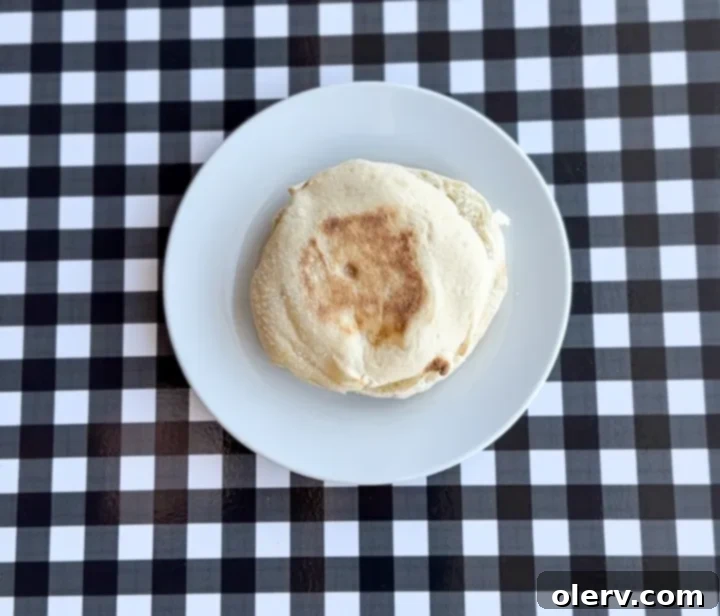 Instant Breakfast Sandwich 11 Step 7: Toasted English muffin on a plate, ready for the filling