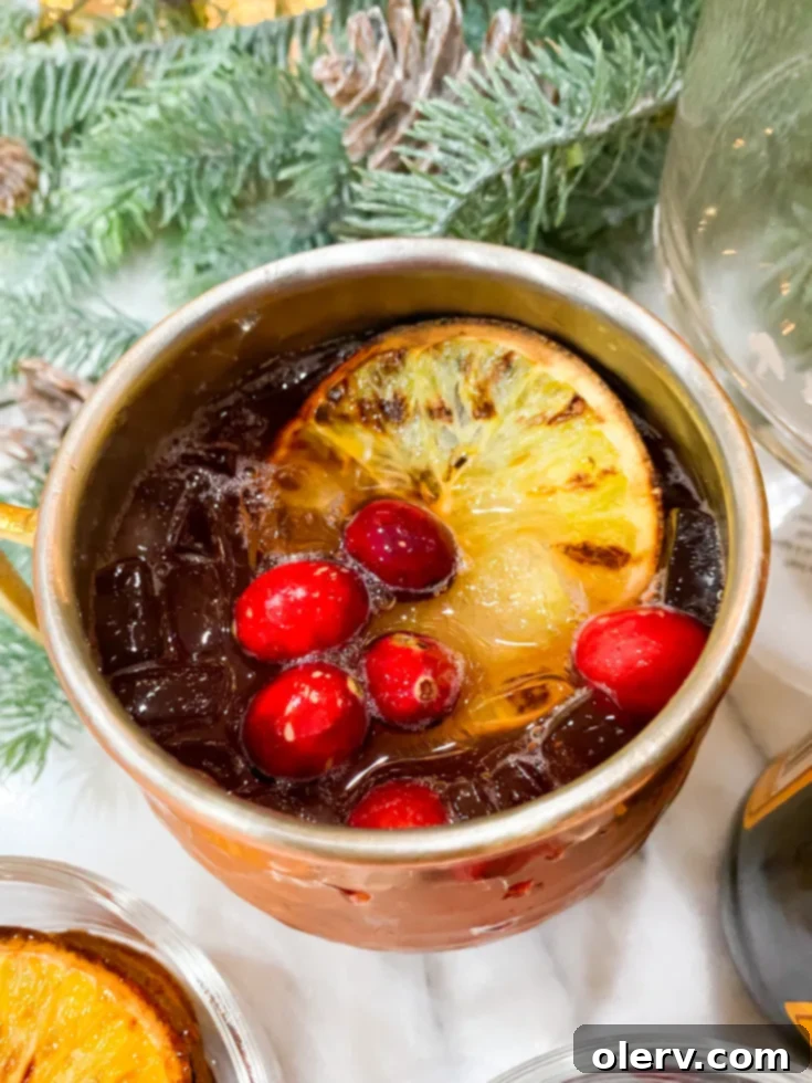 Pin to Pinterest: Cranberry Orange Mocktail recipe image.