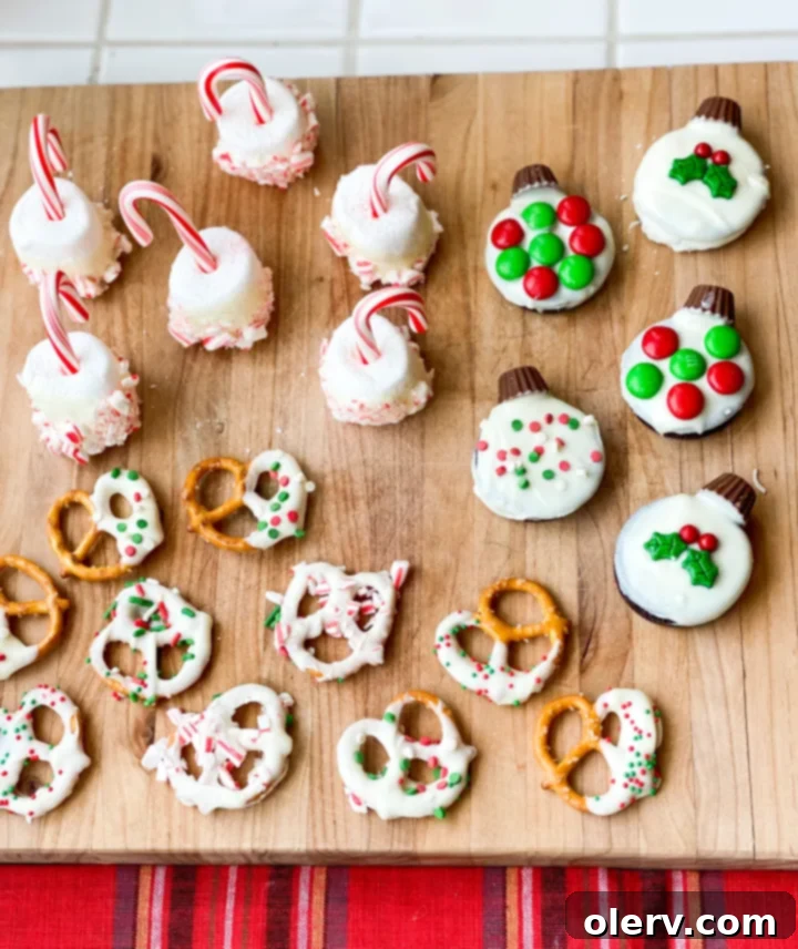 Stress-Free Holiday Goodies 2 Assortment of homemade easy holiday treats, including festive Oreo ornaments, hot chocolate stir sticks, and chocolate-covered pretzels on a white platter