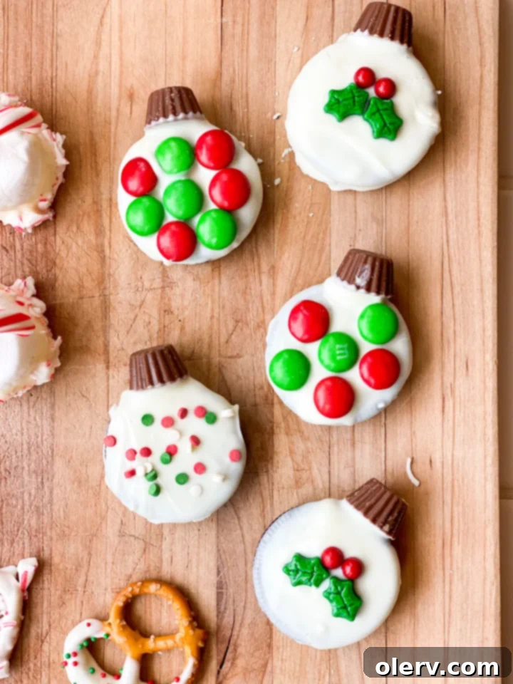 Stress-Free Holiday Goodies 4 White chocolate-dipped Oreo ornament decorated with red and green sprinkles, topped with a mini Reese's cup