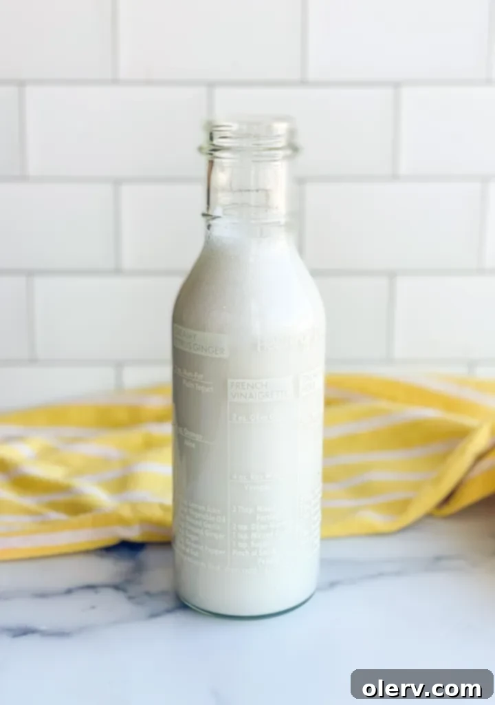 Liquid Coconut Gold 6 Pitcher of homemade coconut syrup on a kitchen counter