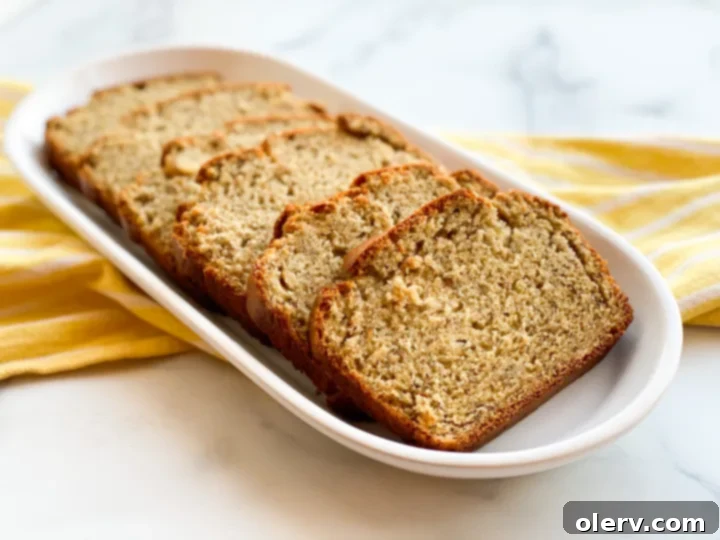Tangy Twist Banana Loaf 3 Sourdough banana bread cooling on a wire rack, showing its beautiful golden-brown top
