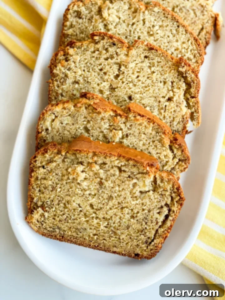 Tangy Twist Banana Loaf 8 Beautifully sliced sourdough banana bread loaf with a golden-brown crust