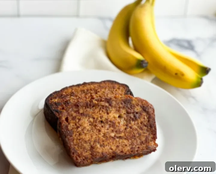 Heavenly Banana Bread French Toast 3 Close-up of golden-brown Banana Bread French Toast on a plate with fresh bananas