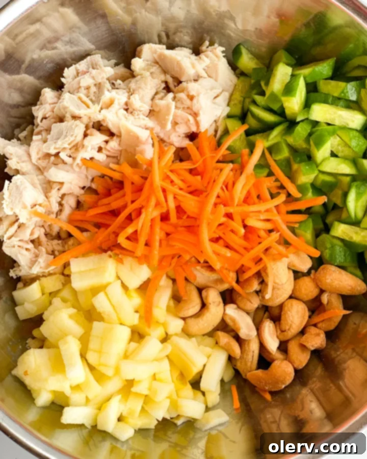 Aromatic Curry Chicken Salad 4 Ingredients for Curry Chicken Salad laid out on a white surface