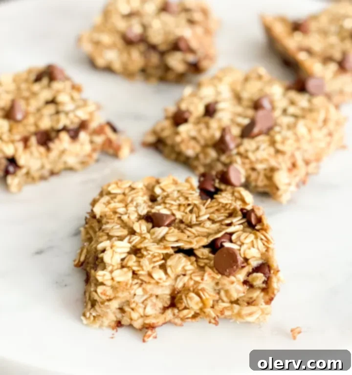 Golden Banana Baked Oats 2 Delicious slices of banana baked oatmeal with chocolate chips ready to be served