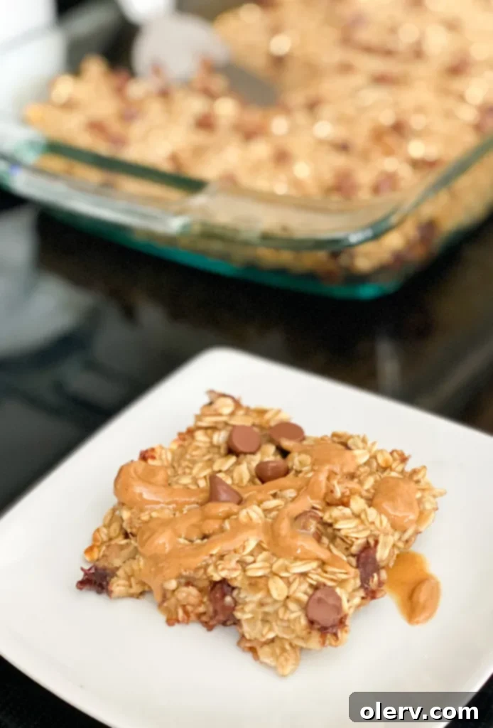 Golden Banana Baked Oats 4 A single serving of banana baked oatmeal on a plate, garnished with fresh banana slices and a drizzle of syrup