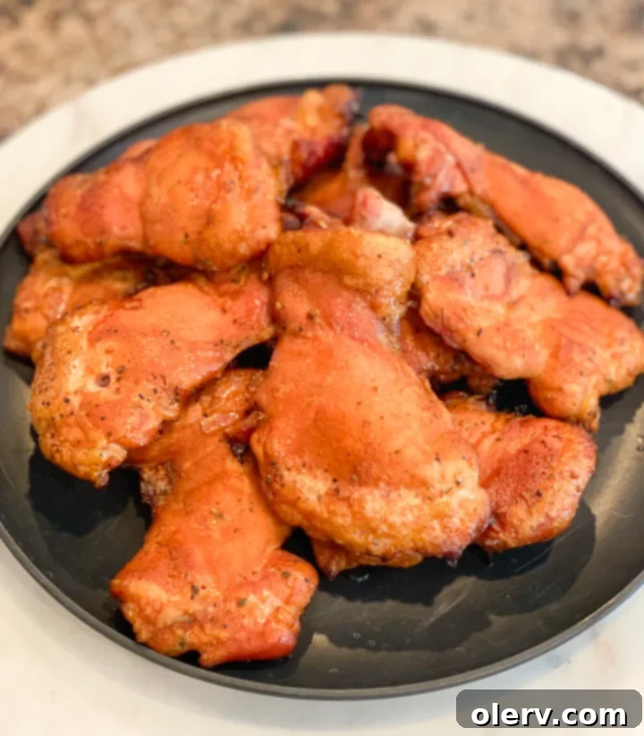 Succulent Smoked Boneless Chicken Thighs 6 Smoked boneless chicken thighs cooking on a pellet grill, smoke visible